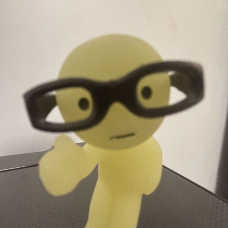 smiski figurine wearing black squared-glasses